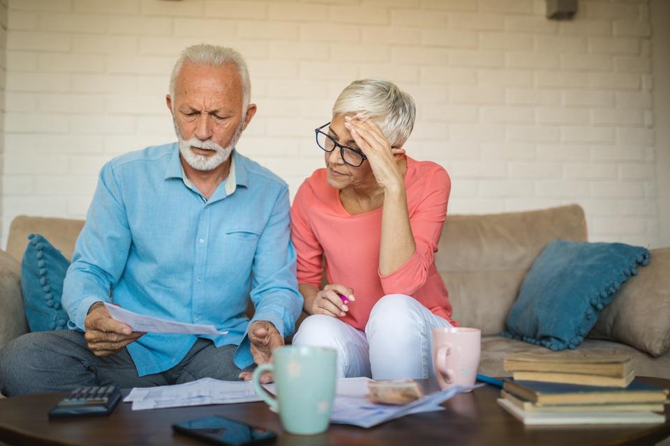 Senior couple brainstorming the solution to a financial problem