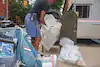 A postal worker collects packages along his route in New York City in September 2020.


