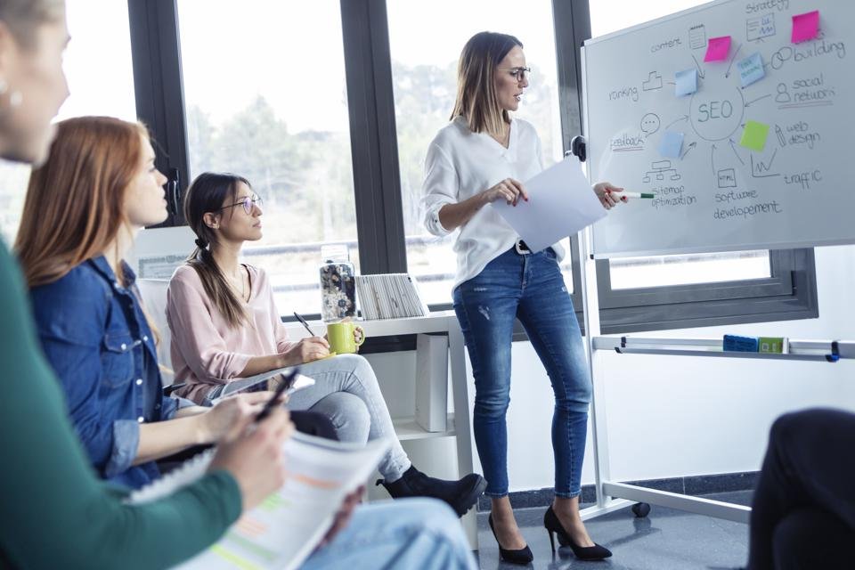 Businesswomen during meeting at a flipchart, presenting ideas for a search engine optimisation