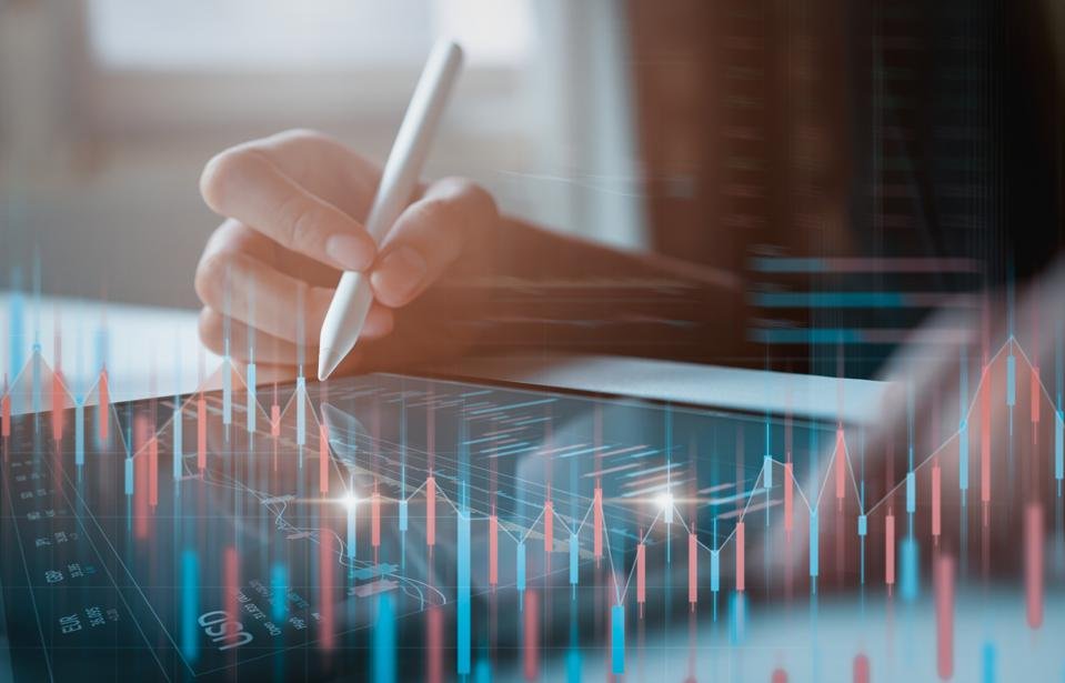 Businessman trader looking on tablet with graphs analysis candle line