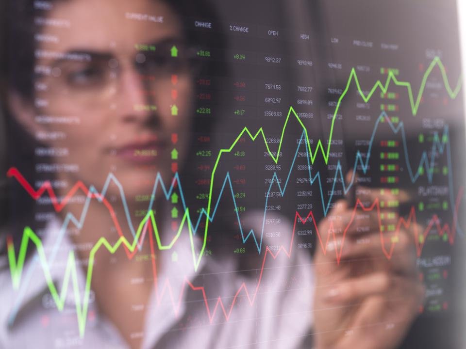 Female analyst viewing financial market data on a screen